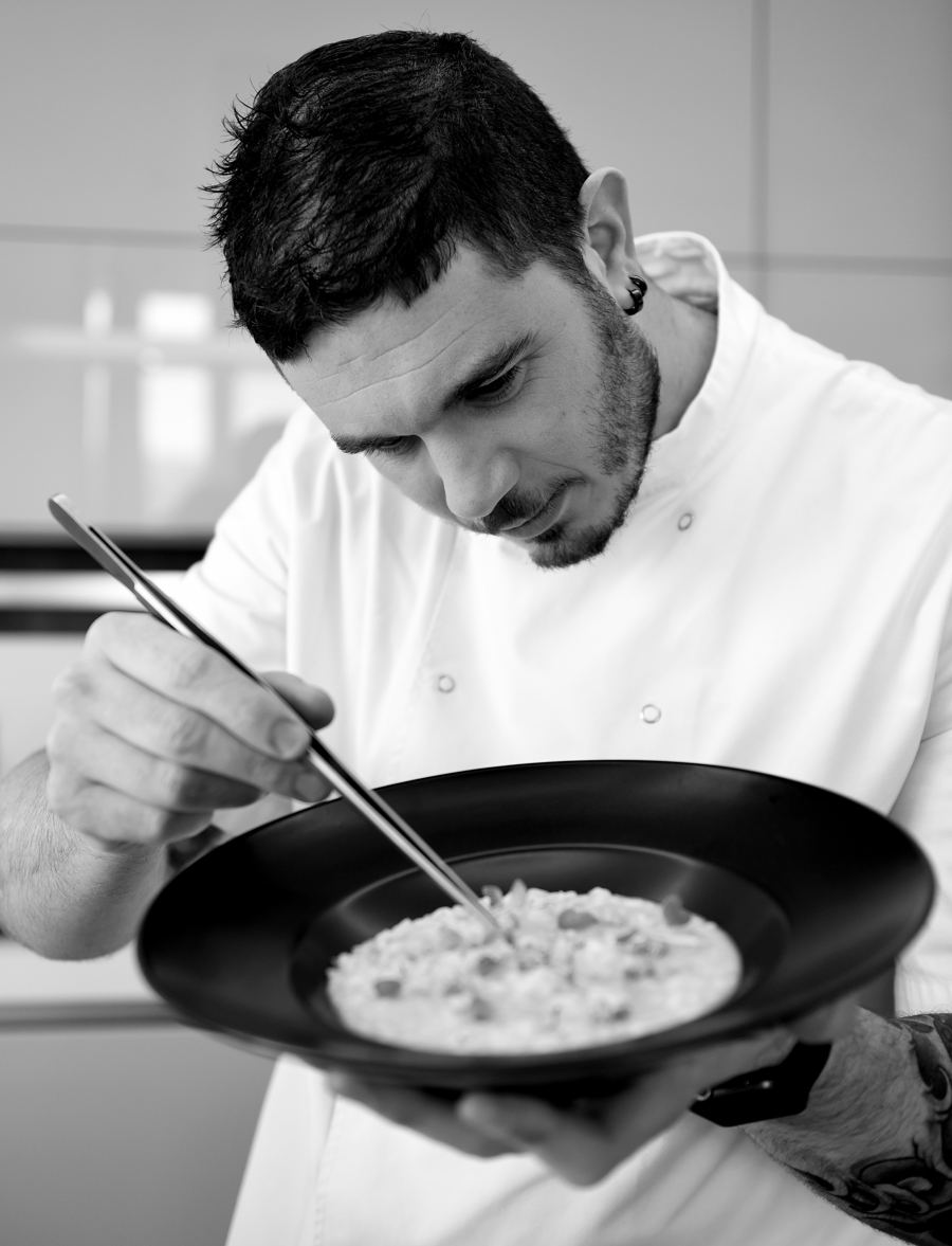 Sean Gravina plating a dish in a professional kitchen